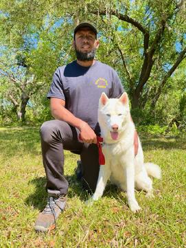 A.J. Miller. shown here with a young Siberian Husky, is one of Euro Pros' Certified Trainers that specializes in Obedience training and Behavior Modification.