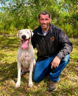 Anthony Pursel. shown here with his young Argentine Dogo, is one of Euro Pros' Certified Trainers that specializes in Obedience training and Behavior Modification.