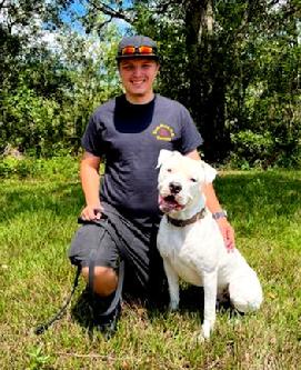 Brandon Baughman. shown here with a young American Bulldog, is one of Euro Pros' Certified Trainers that specializes in Obedience training and Behavior Modification.