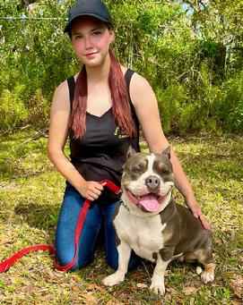 Lilly Gibson. shown here with clients' Bully Dog, "Paisley". Lilly is Euro Pros' Training Director & a Certified Trainer that specializes in Obedience training, Behavior Modification and Service Dog Training.